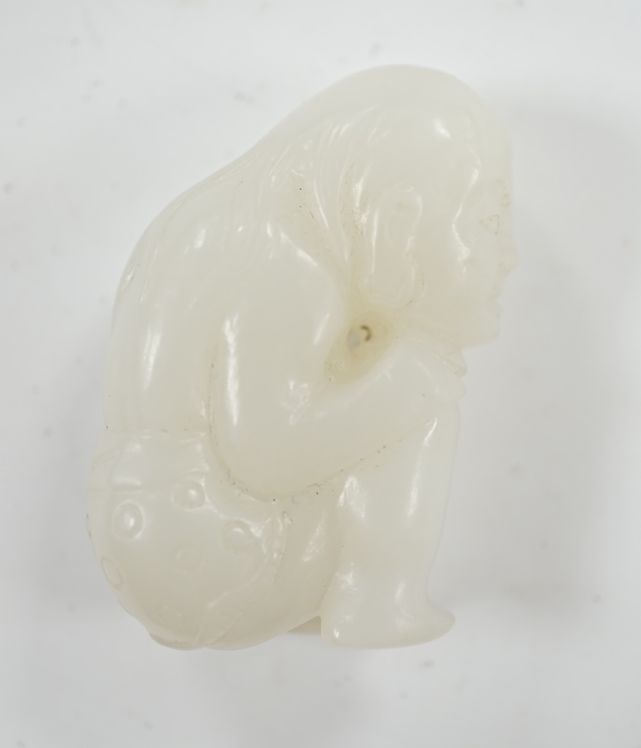 A Chinese white jade carving of a crouching figure, 4.5cm high. Condition - good